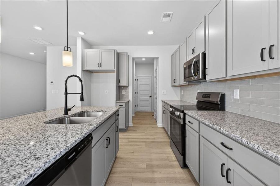 Furnished interior view inside a new home in Trinity Station, Auburn (Image 7).