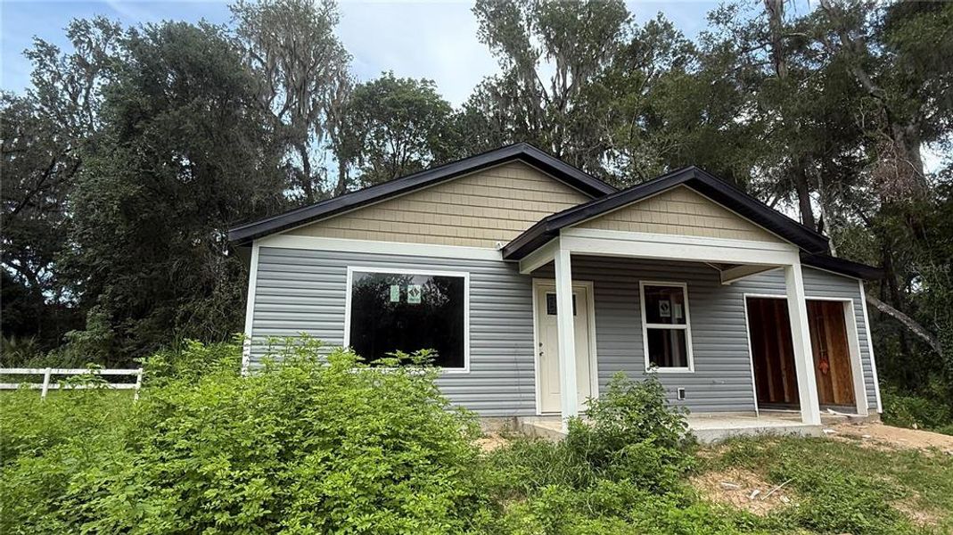 Front exterior of a new home in , Belleview, FL, highlighting curb appeal (Image 1).