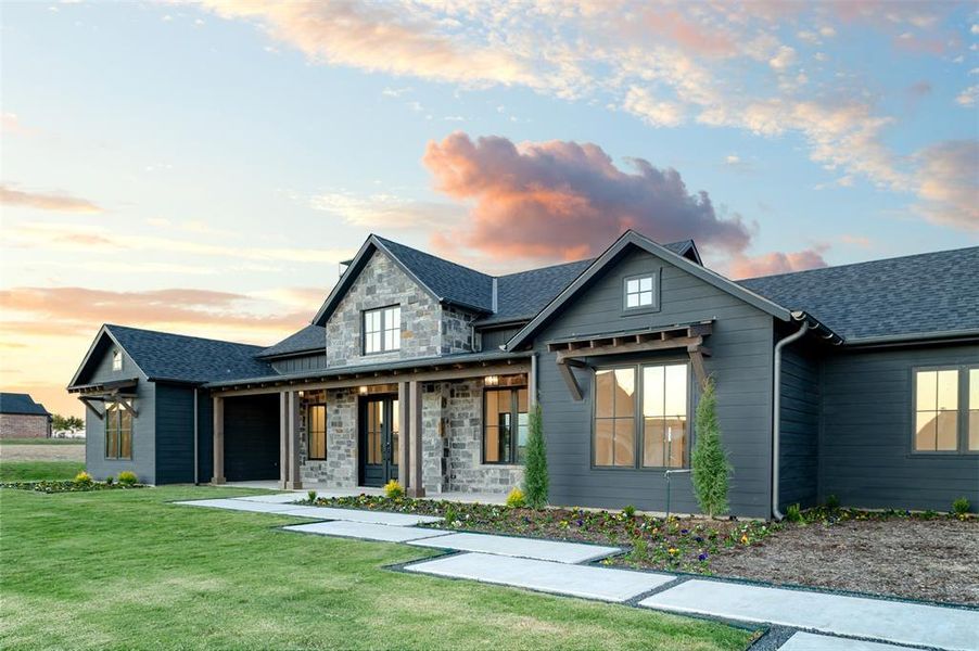 View of front of home featuring a yard and a porch