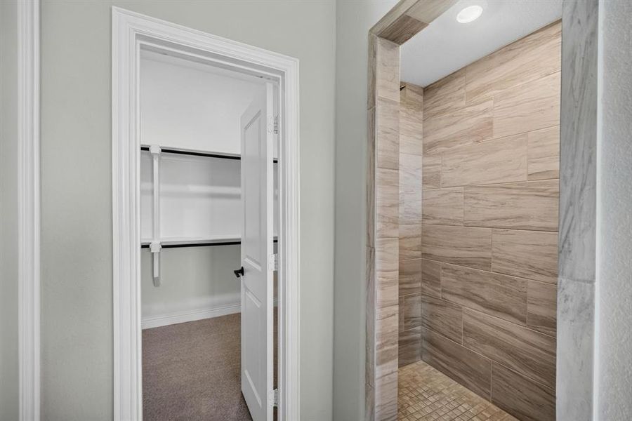 Walk-in shower with large format tile walls and a mosaic tile floor