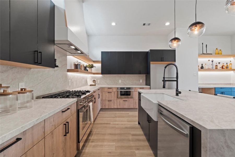 The Taj Mahal quartz continues up the backsplash, giving the kitchen an elevated, seamless look while making cleanup a breeze. The Taj Mahal quartz continues up the backsplash, giving the kitchen an elevated, seamless look while making cleanup a breeze.