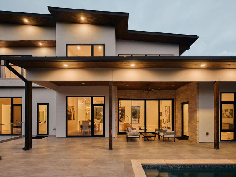 A modern architectural marvel showcasing sleek lines and illuminated outdoor living spaces. A modern architectural marvel showcasing sleek lines and illuminated outdoor living spaces.