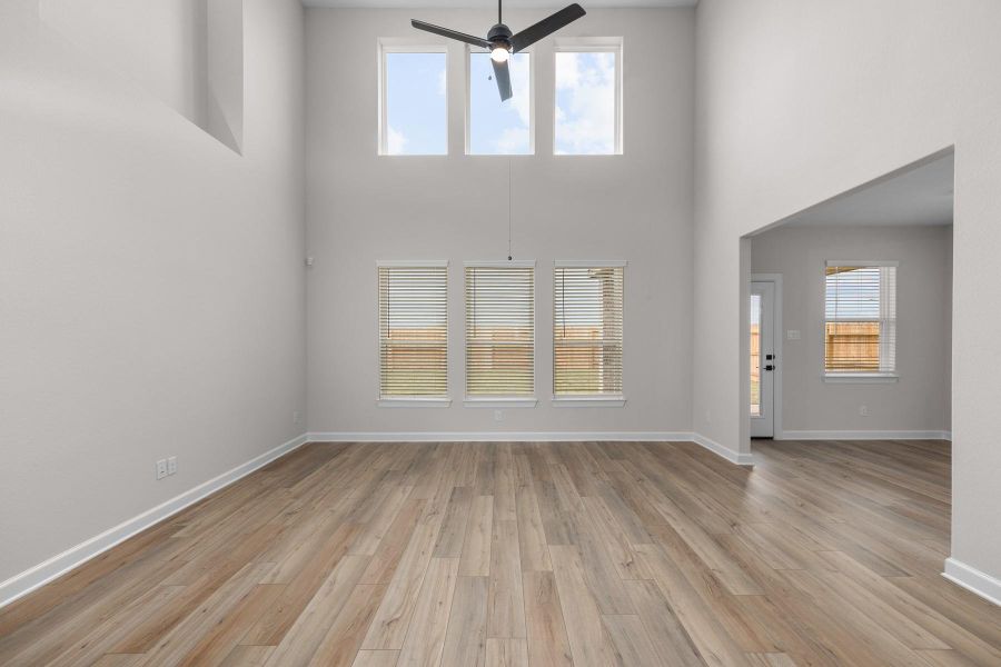 The spacious family room features floor to ceiling windows providing plenty of natural light. The spacious family room features floor to ceiling windows providing plenty of natural light.