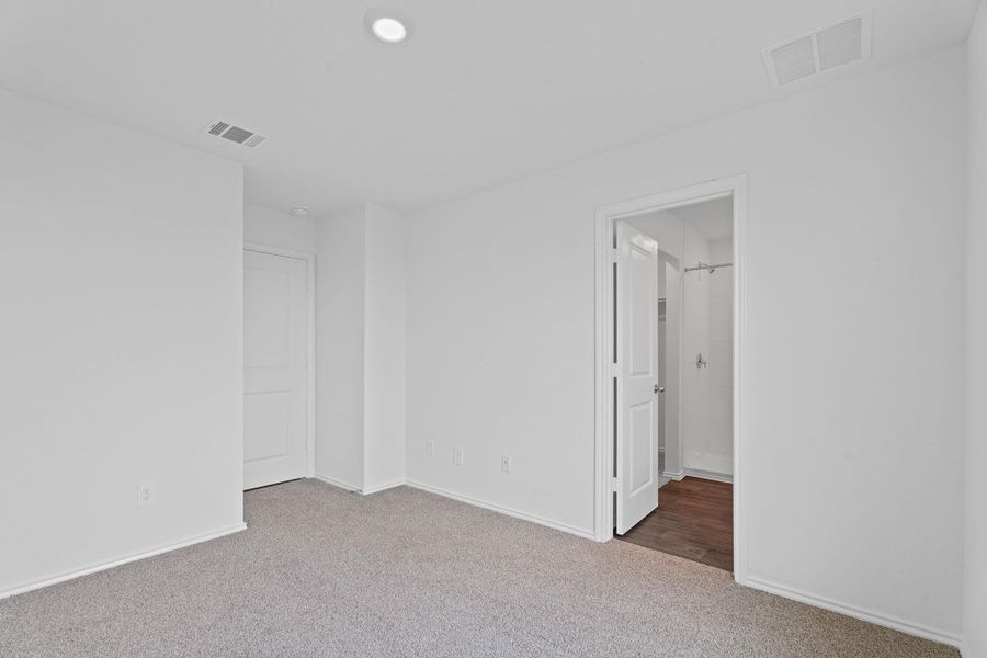 Spare room with carpet flooring, visible vents, and baseboards Spare room with carpet flooring, visible vents, and baseboards