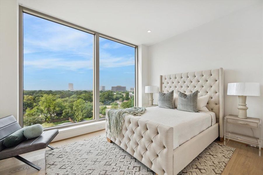 En-suite guest bedroom with natural light pouring in through floor-to-ceiling windows, creating a warm and inviting atmosphere.