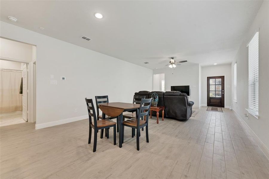 Dining space featuring light wood-type flooring, recessed lighting, and a ceiling fan Dining space featuring light wood-type flooring, recessed lighting, and a ceiling fan