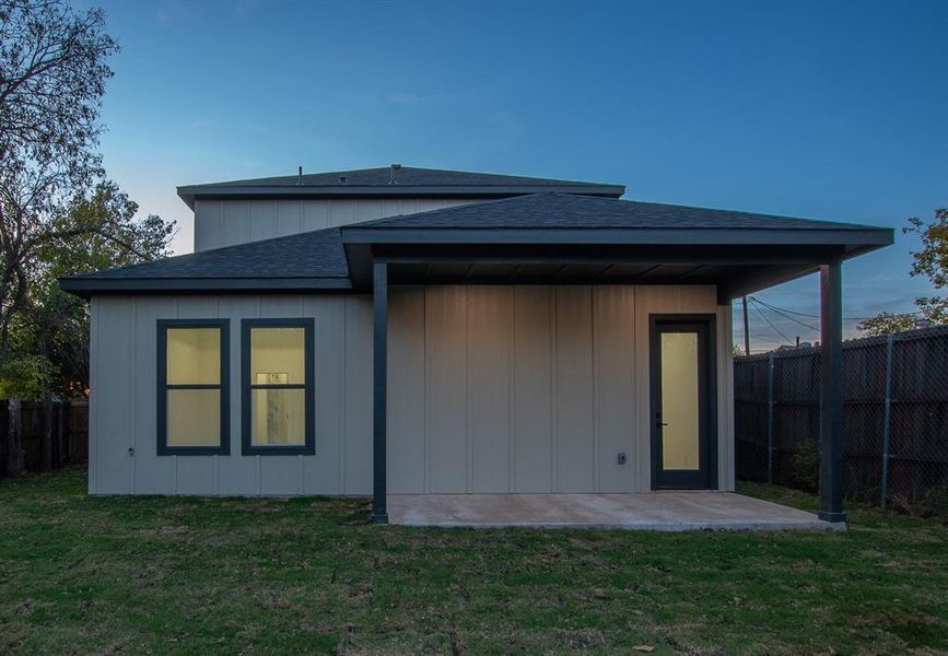 Back of property featuring a covered patio