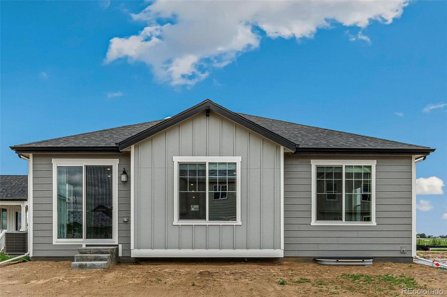 Front exterior of a new home in Farmlore, Brighton, CO, highlighting curb appeal (Image 22).