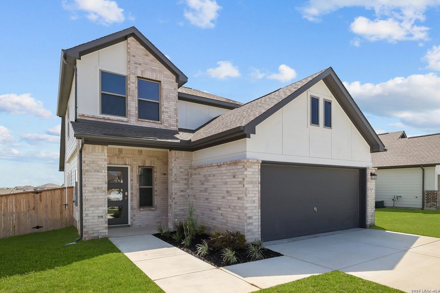 Front exterior of a new home in The Parklands, Schertz, TX, highlighting curb appeal (Image 23).