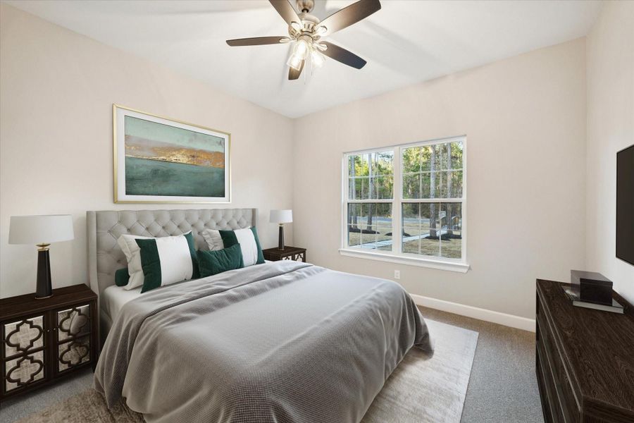 Secondary bedroom staged with furniture.  Large window looks to the front of the home.