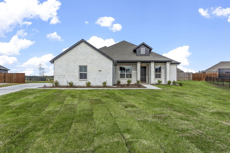 Representative exterior photo of a completed home built from the Logan II by Robbie Hale Homes in High Meadows Estates, Nevada, TX (Image 1). Representative exterior photo of a completed home built from the Logan II by Robbie Hale Homes in High Meadows Estates, Nevada, TX (Image 1).