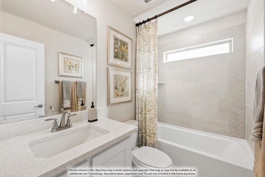 Bathroom with quartz vanity, white tub, herringbone tile surround, and floral shower curtain