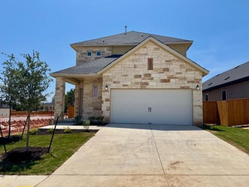 Front exterior of a new home in Heritage, Dripping Springs, TX, highlighting curb appeal (Image 2). Front exterior of a new home in Heritage, Dripping Springs, TX, highlighting curb appeal (Image 2).