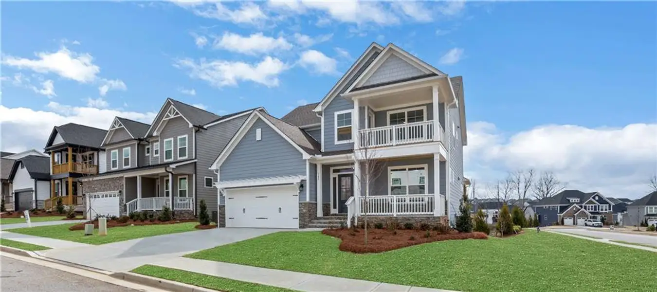 Front exterior of a new home in Twin Lakes, Hoschton, GA, highlighting curb appeal (Image 1). Front exterior of a new home in Twin Lakes, Hoschton, GA, highlighting curb appeal (Image 1).