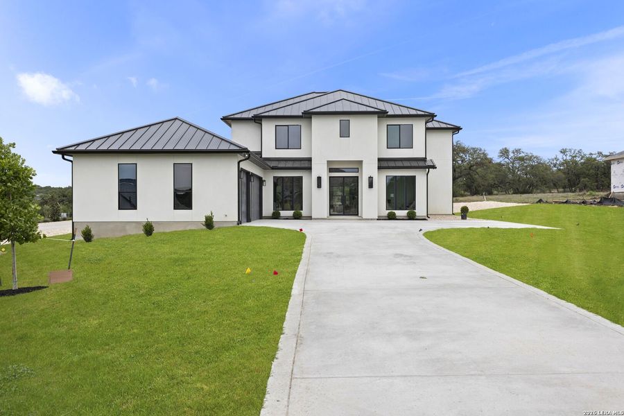 Front exterior of a new home in , Bulverde, TX, highlighting curb appeal (Image 27).