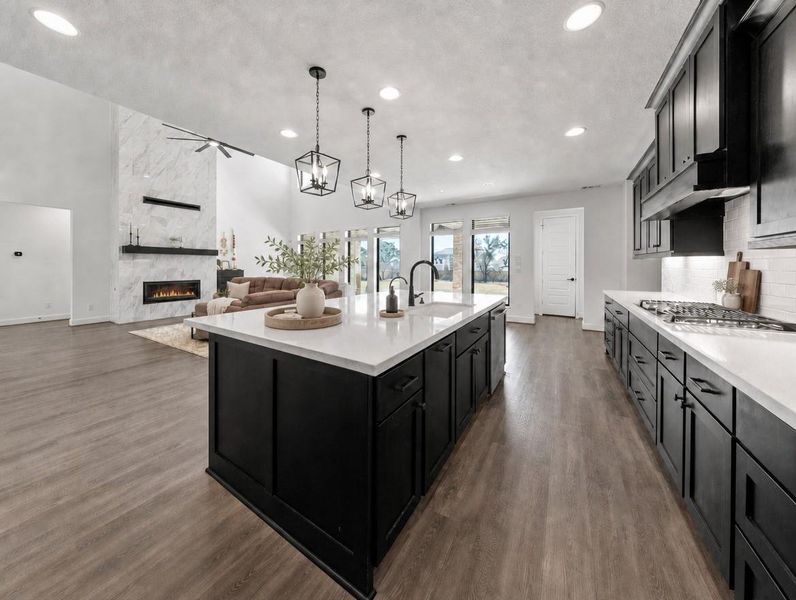 An open concept design seamlessly connects the sleek, well-appointed kitchen with the spacious living area. An open concept design seamlessly connects the sleek, well-appointed kitchen with the spacious living area.