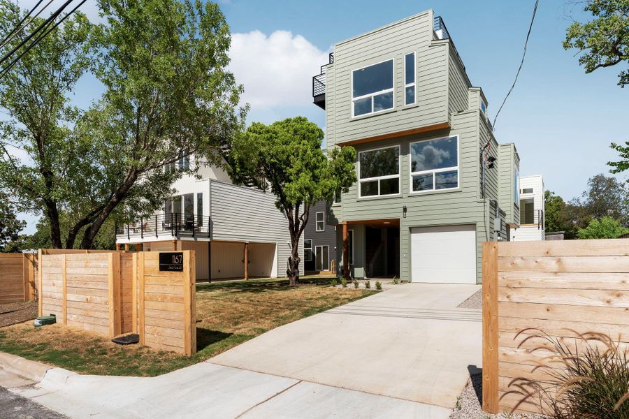 Modern home featuring concrete driveway and a garage