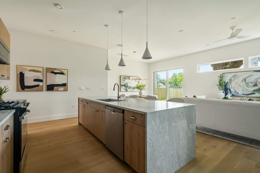 A grand marble island with contemporary pendant lights creates an inviting kitchen space. A grand marble island with contemporary pendant lights creates an inviting kitchen space.