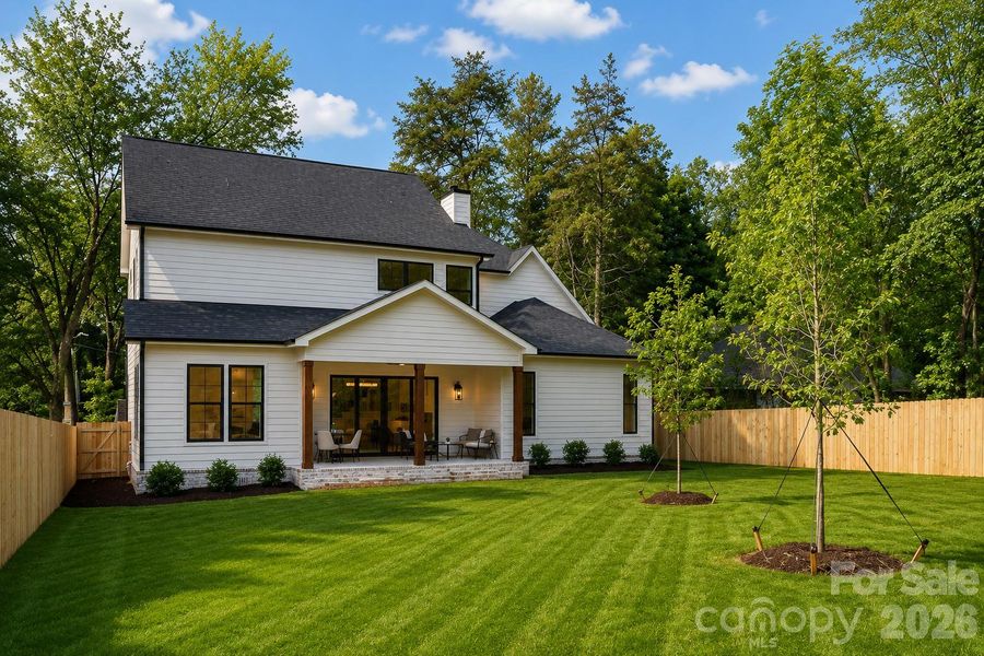 Flat open back yard -full private fence. Backyard is seeded, grass in photo is AI generated