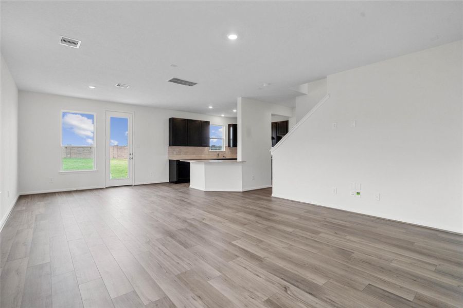 Spacious open-concept design seamlessly connecting the living, dining, and kitchen areas—perfect for both everyday living and entertaining!