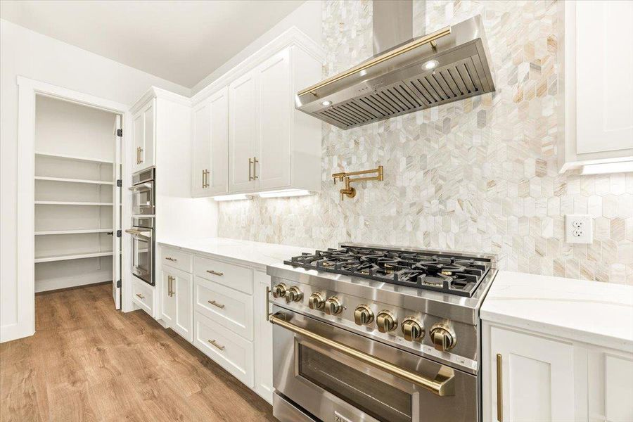 Culinary dreams come to life with this gourmet kitchen's stainless steel appliances and ample pantry space.