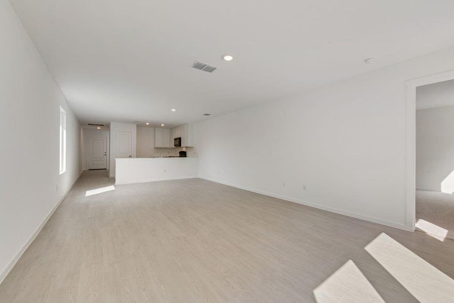 Unfurnished living room featuring light wood-style floors and recessed lighting