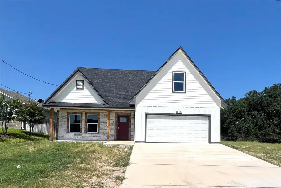 Front exterior of a new home in , Lampasas, TX, highlighting curb appeal (Image 1).