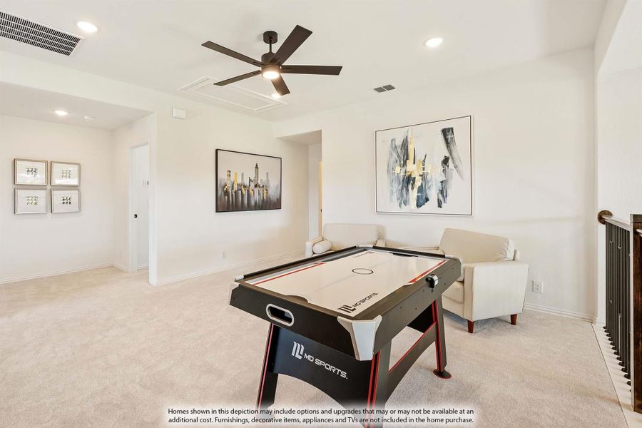 Game room with air hockey table, ceiling fan, carpet flooring, and neutral walls with framed artwork Game room with air hockey table, ceiling fan, carpet flooring, and neutral walls with framed artwork