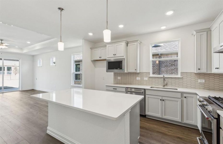 Bright kitchen with ample cabinet space with oversized island *real home pictured Bright kitchen with ample cabinet space with oversized island *real home pictured
