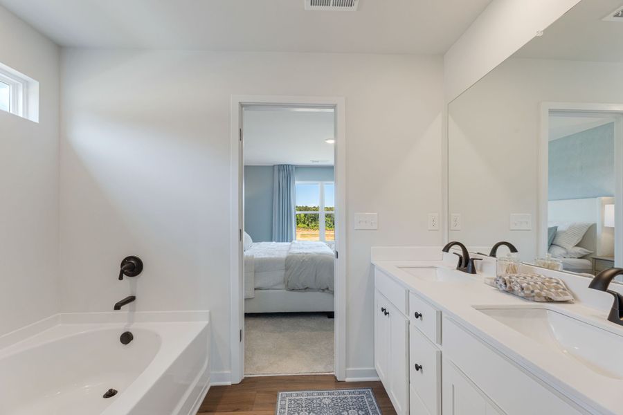A bathroom with a tub sink and a bathtub. A bathroom with a tub sink and a bathtub.