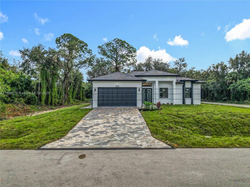 Front exterior of a new home in , Lehigh Acres, FL, highlighting curb appeal (Image 1).