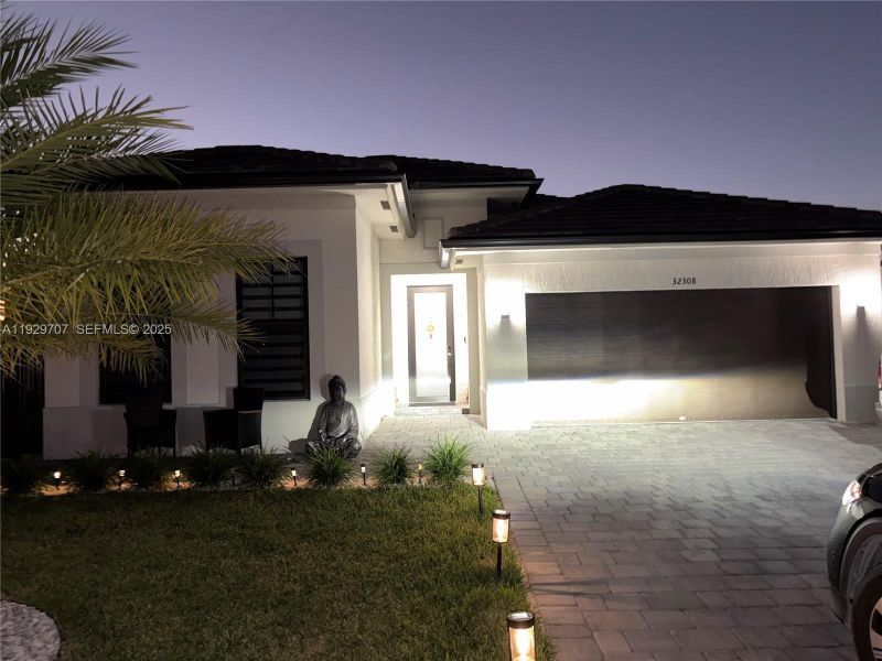 Front exterior of a new home in , Homestead, FL, highlighting curb appeal (Image 1). Front exterior of a new home in , Homestead, FL, highlighting curb appeal (Image 1).