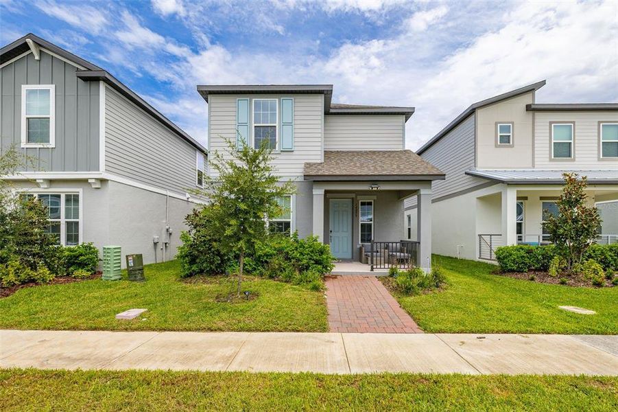 Front exterior of a new home in Highland Ridge, Winter Garden, FL, highlighting curb appeal (Image 23).