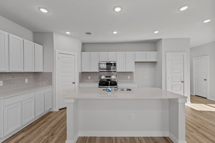 A kitchen with white cabinets. A kitchen with white cabinets.