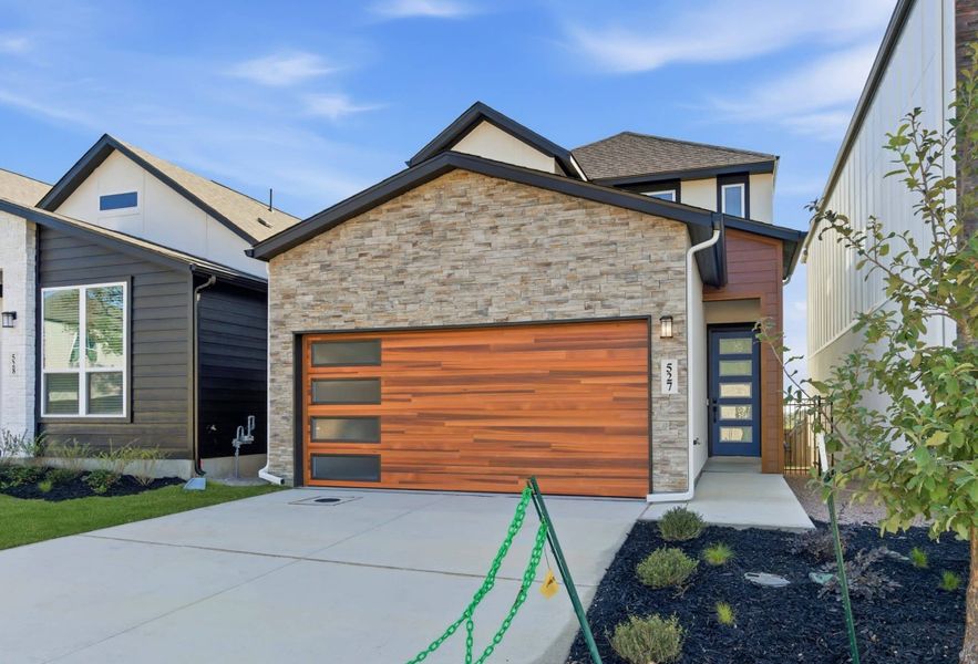 Front exterior of a new home in Centero at Stone Oak, San Antonio, TX, highlighting curb appeal (Image 20).