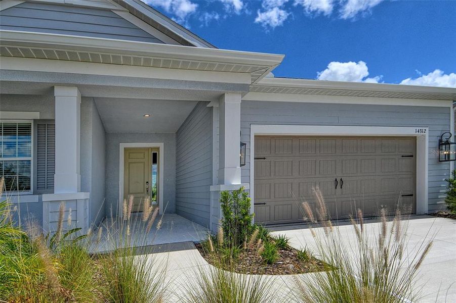 Front exterior of a new home in Canoe Creek, Parrish, FL, highlighting curb appeal (Image 19).