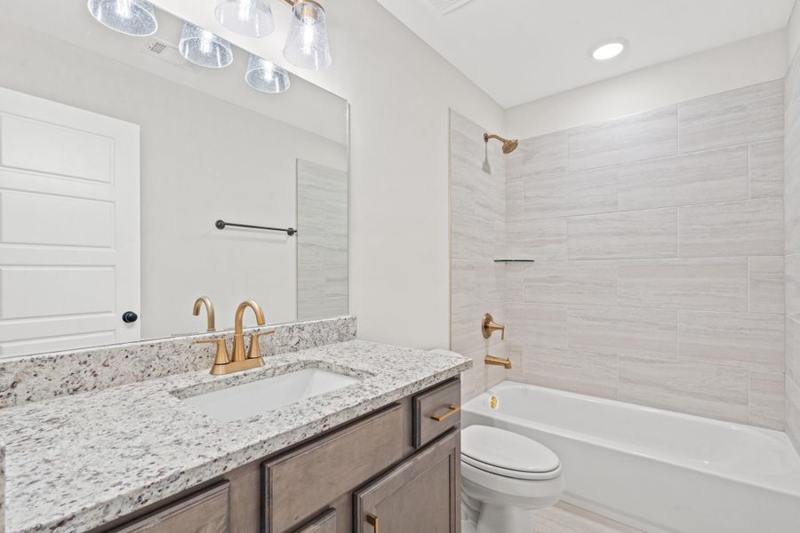 Bathroom with vanity and shower / washtub combination