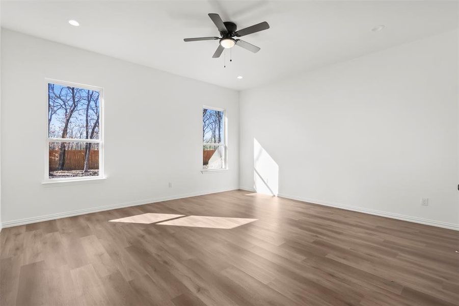 Spare room with hardwood / wood-style flooring and ceiling fan