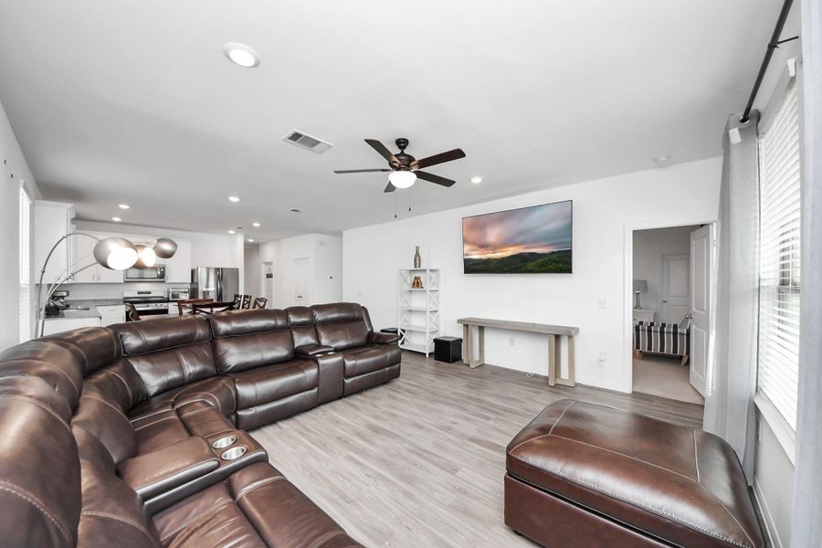 Greeted by open floor plan kitchen/dining/living area