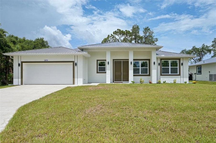 Front exterior of a new home in , North Port, FL, highlighting curb appeal (Image 2).