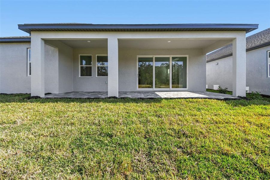 Exterior details and patio area of a home in Creeks Edge at Twin Rivers, Parrish (Image 3).