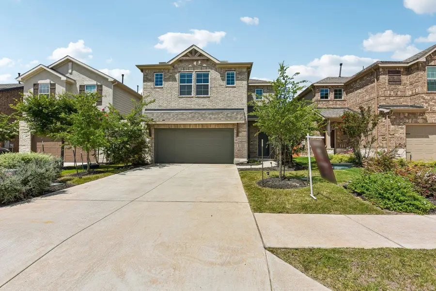 A classic brick exterior and well-maintained landscaping define this inviting suburban home.