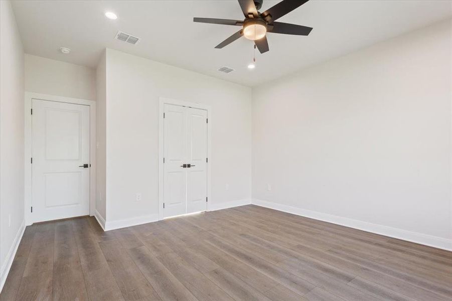 Unfurnished bedroom with wood finished floors, recessed lighting, ceiling fan, and a closet Unfurnished bedroom with wood finished floors, recessed lighting, ceiling fan, and a closet