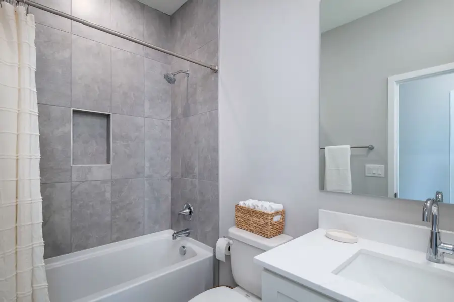 A bright and stylish secondary bathroom offering modern tilework, clean lines, and a functional layout for guests or family members. A bright and stylish secondary bathroom offering modern tilework, clean lines, and a functional layout for guests or family members.