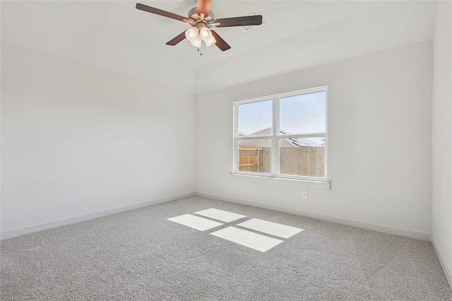 Unfurnished room featuring carpet and ceiling fan