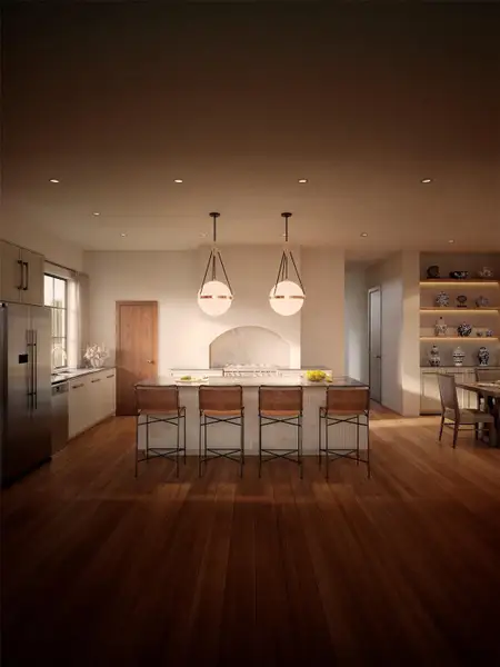 An inviting kitchen features a grand island with bar seating, illuminated by unique pendant lights. An inviting kitchen features a grand island with bar seating, illuminated by unique pendant lights.