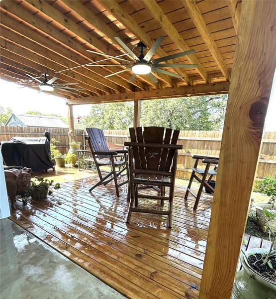 Enjoy outdoor living on this covered deck with ample space and overhead fans. Enjoy outdoor living on this covered deck with ample space and overhead fans.