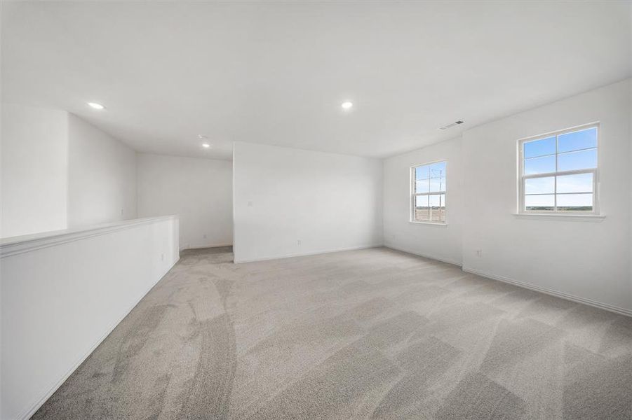 Unfurnished room featuring light carpet and recessed lighting Unfurnished room featuring light carpet and recessed lighting