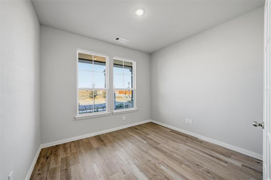 Unfurnished room featuring light wood-style floors and baseboards Unfurnished room featuring light wood-style floors and baseboards