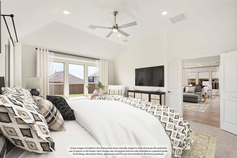 Spacious master bedroom with vaulted ceiling, ceiling fan, large windows, and open view to living area Spacious master bedroom with vaulted ceiling, ceiling fan, large windows, and open view to living area